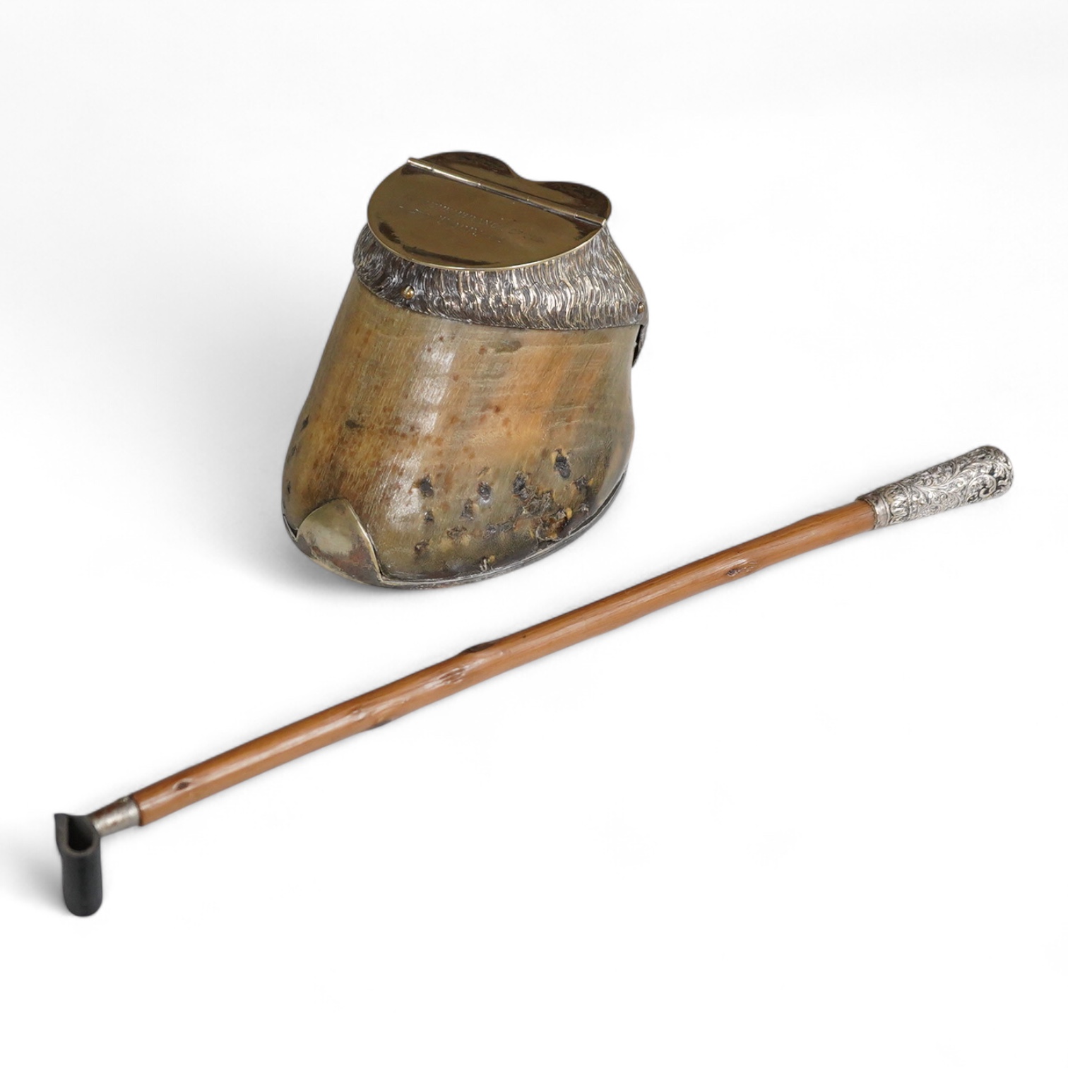 A Victorian electroplate mounted memorial horse hoof inkwell, 11cm high and a white metal mounted riding crop